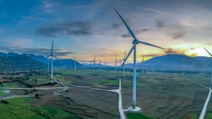 Aerogeneradores en un valle con montañas al atardecer